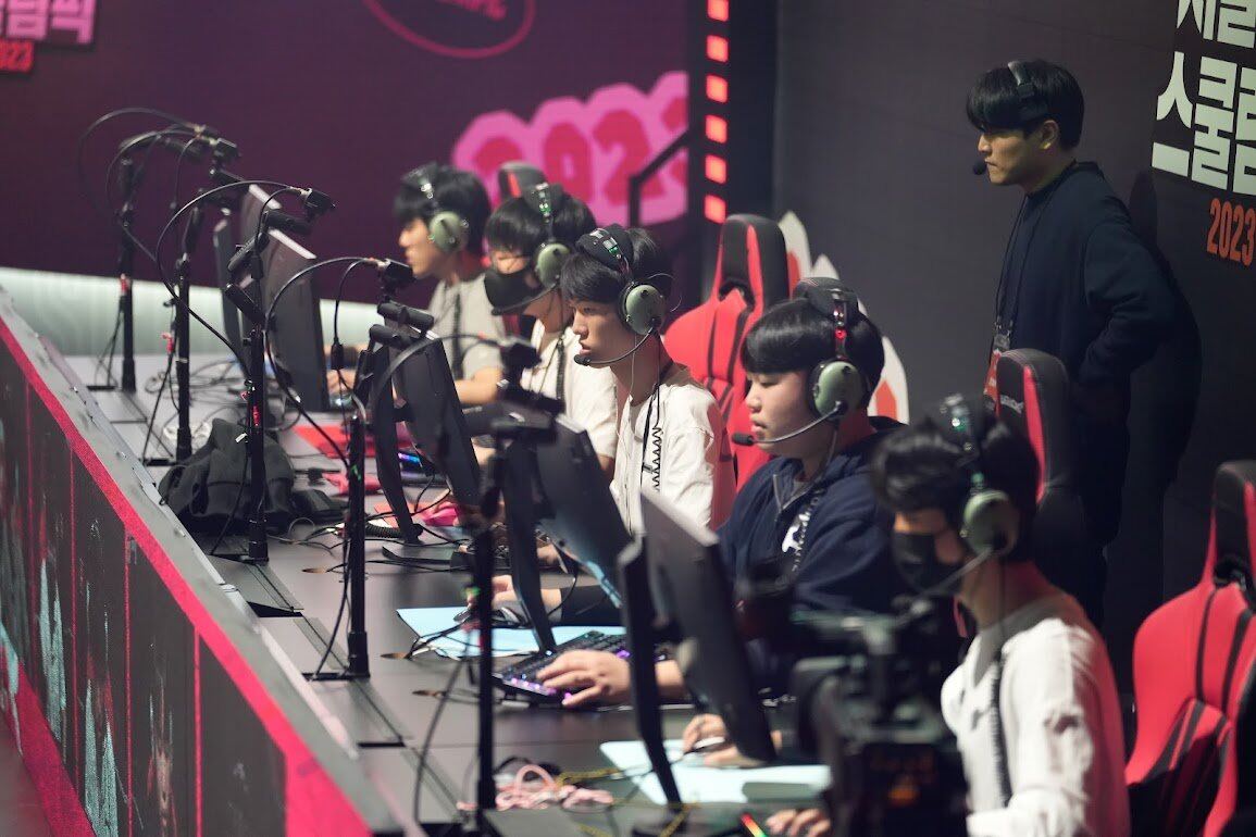 Students competing at an esports tournament station