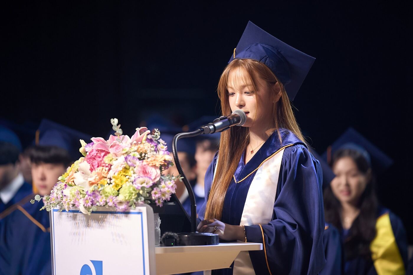 A graduating senior speaking at the Class of 2025 commencement