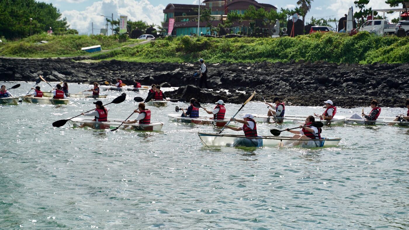 Students kayaking together on open water during a field program